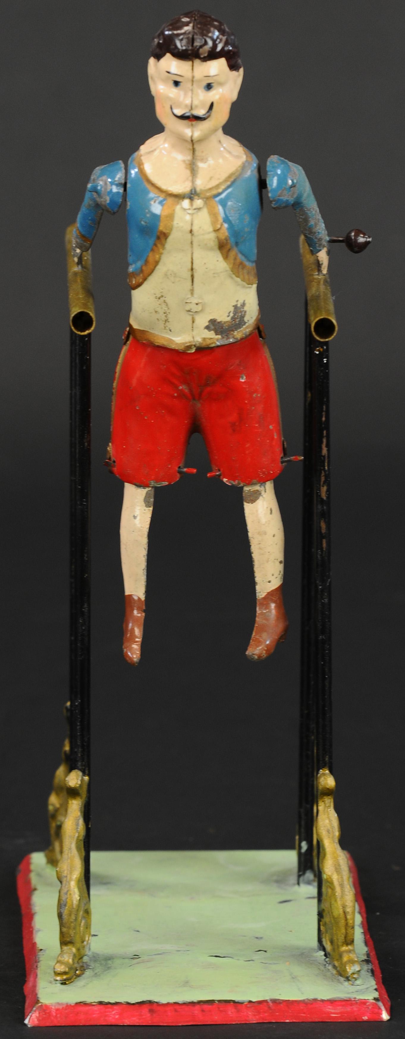 HANS EBERL GYMNAST ON PARALLEL BARS: 1127. HANS EBERL GYMNAST ON PARALLEL BARS | Outstanding example, early German toy is hand painted in circus performer outfit, great balance helps the toy seemingly defy gravity as the gymnast performs