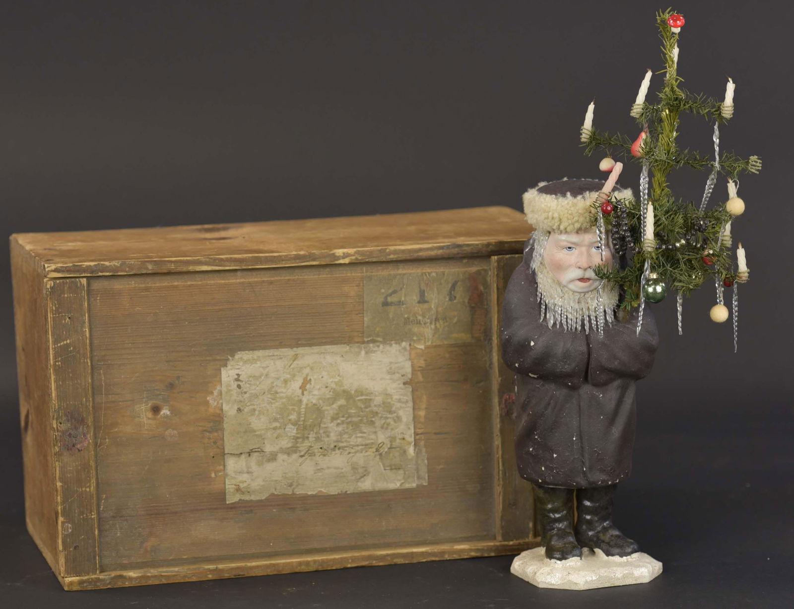 BELSNICKLE W/ GLASS BEARD & HAIR: 1784. BELSNICKLE W/ GLASS BEARD & HAIR | This seldom seen Belsnickle figure is made of composition to resemble chalk, this candy container figure is dressed in a long, dark brown robe, he has a determ