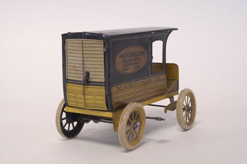 HANS EBERL ''METROPOLITAN HARDWARE'' DELIVERY VAN: Germany, c. 1920, promotional store item toy, made for New York based hardware store, done in yellow and black tin lithography, seated driver, opening rear doors, clockwork driven. 7 1/2'' long.
