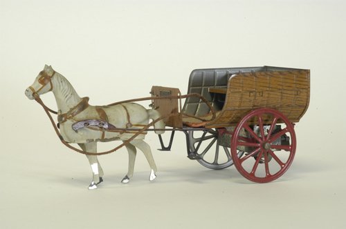 VICTOR BONNET HORSE DRAWN CART: France, lithographed tin, cart done in simulated wood grain finish, white horse is full figured, bonnet plate on buckboard,red hitch, clockwork driven. 9 1/4'' long