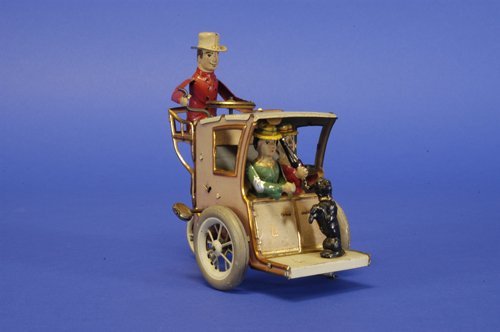 LEHMANN ''LI LA'' HANSOM CAB: Germany, lithographed and hand painted tin, coach driver seated at rear roof of cab holding two seated ladies and dog by footrest, clockwork action also includes woman putting umbrella through trap do