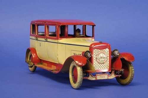 LEHMANN ''LUXUS'' SEDAN: Germany, another in the largest of Lehmann's auto line, done in lithographed tin, red and white overall, reads ''LUXUS,'' at sides, disc wheels, clockwork driven, with electric lights. 12 1/2'' long.