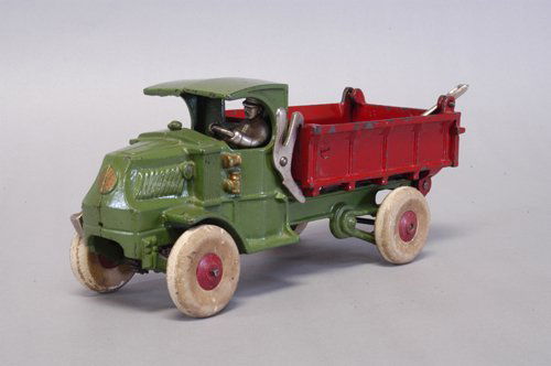 HUBLEY CLOCKWORK MACK DUMP TRUCK: c. 1930's, rarest of the Hubley work vehicles, a striking cast iron green Mack ''C'' Cab with bright red dump body controlled by nickel tilt lever, this incredible example features a clockwork motor w