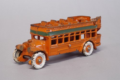 KENTON CITY BUS: Circa 1930's, cast iron, a scarce size; painted in orange with green band, disc wheels done in white, upper deck seating, rear stairs, gold trimmed headlights. 6 1/2'' long.