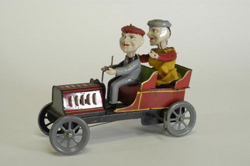 HANS EBERL CLOWN CAR: Germany, c. 1920's, whimsical handpainted and lithographed tin auto with two comical figures seated in open tourer, spoke wheels, clockwork actions cause rear figure to jump up and down while driver's