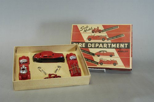HUBLEY BOXED FIRE DEPT. SET: Well matched set includes: cast iron police cycle, plastic ladder truck, fire chief auto and fire pumper, two nickel cast axes also included in set. 4'' to 5'' long.