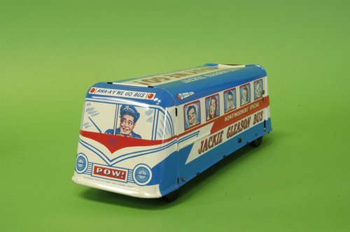WOLVERINE BOXED JACKIE GLEASON BUS: Colorful lithographed tin bus, graphics depict cast of the Honeymooners with Jackie Gleason at the wheel, minor dent to press-down area. 14'' long.