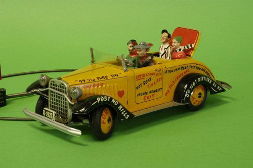 ARNOLD BOXED ''TIN LIZZY'': Lithographed tin, colorful open auto, contains four composition figures, hand control activates forward motion and steering, graphic wording overall. 9'' long.
