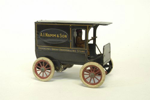 HANS EBERL '' A.I. NAMM & SON'' DELIVERY VAN: Germany, c. 1920's, lithographed tin, made for Brooklyn Department store, done in black body, gold lettering, opening rear doors, seated driver, clockwork driven, very rare example. 7 1/2'' long.
