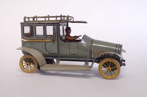 HANS EBERL LIMOUSINE: Germany, c. 1910, large teal and blue limo with gold color striping, features roof rack, seated driver, full running boards, and rivet design grille, rubber tires, spoke wheels done in yellow, clockwo