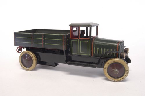 DISTLER STAKE TRUCK: Germany, c. 1920's, lithographed tin, features unusual high stake bed once allowing long tin hand car to be stored on frame, done in green, rivet graphics on bed, seated driver, clockwork driven, a sc