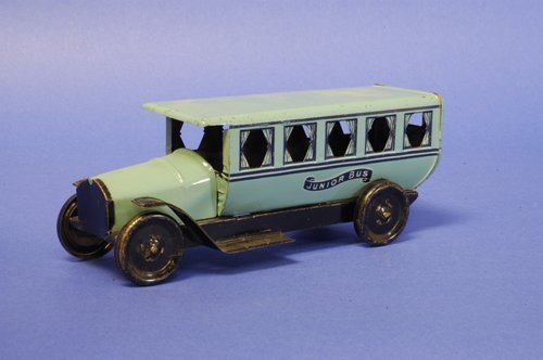 CHEIN ''JUNIOR BUS'': Lithographed tin, done in blue body, curtains on window graphics, reads ''Junior Bus,'' disc wheels done in black. 8 3/4'' long.