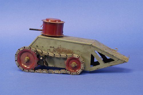 STRUCTO BOXED ''WHIPPET'' TANK: c. 1920, modeled after the Whippet military tank, pressed steel, painted in grey body, red gun turret with protruding barrel, nickel plated treads, clockwork driven, colorful box lid graphics of war s