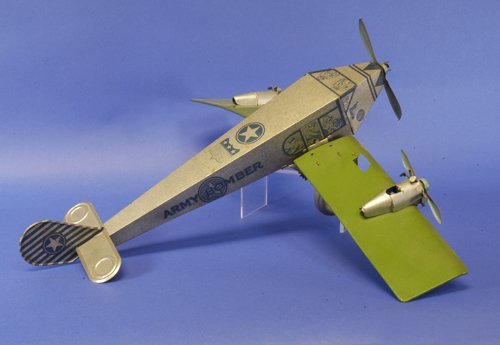 MARX TRI-MOTOR ARMY BOMBER: Includes flattened box, lithographed tin, silver fuselage with extensive graphics, green wing, red props, friction driven monoplane has impressive scale at 26'' wingspan.