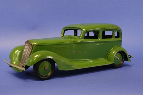 COR-COR GRAHAM SEDAN: c. 1932, pressed steel, painted in lime green, dealer model has impressive scale, nickel plated grille, painted wheel centers, solid rubber tires, front and back bumpers. 20'' long.