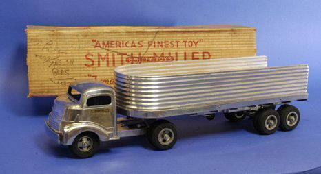 SMITH MILLER BOXED GMC SILVER STREAK EXPRESS: c. late 1940's, tractor and trailer tandem, old store stock, a brightly polished aluminum finish, trailer with matching die-cast cab in chromed look, bed floor contains wooden flooring, rubber tires.