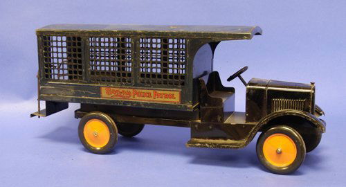 SONNY POLICE PATROL: 1927, pressed steel, painted low open cab with screen side van body, bench seats and rear step with brass hand rails, dark blue body, orange wheels, great decals on Sonny's hardest to find truck. 29''