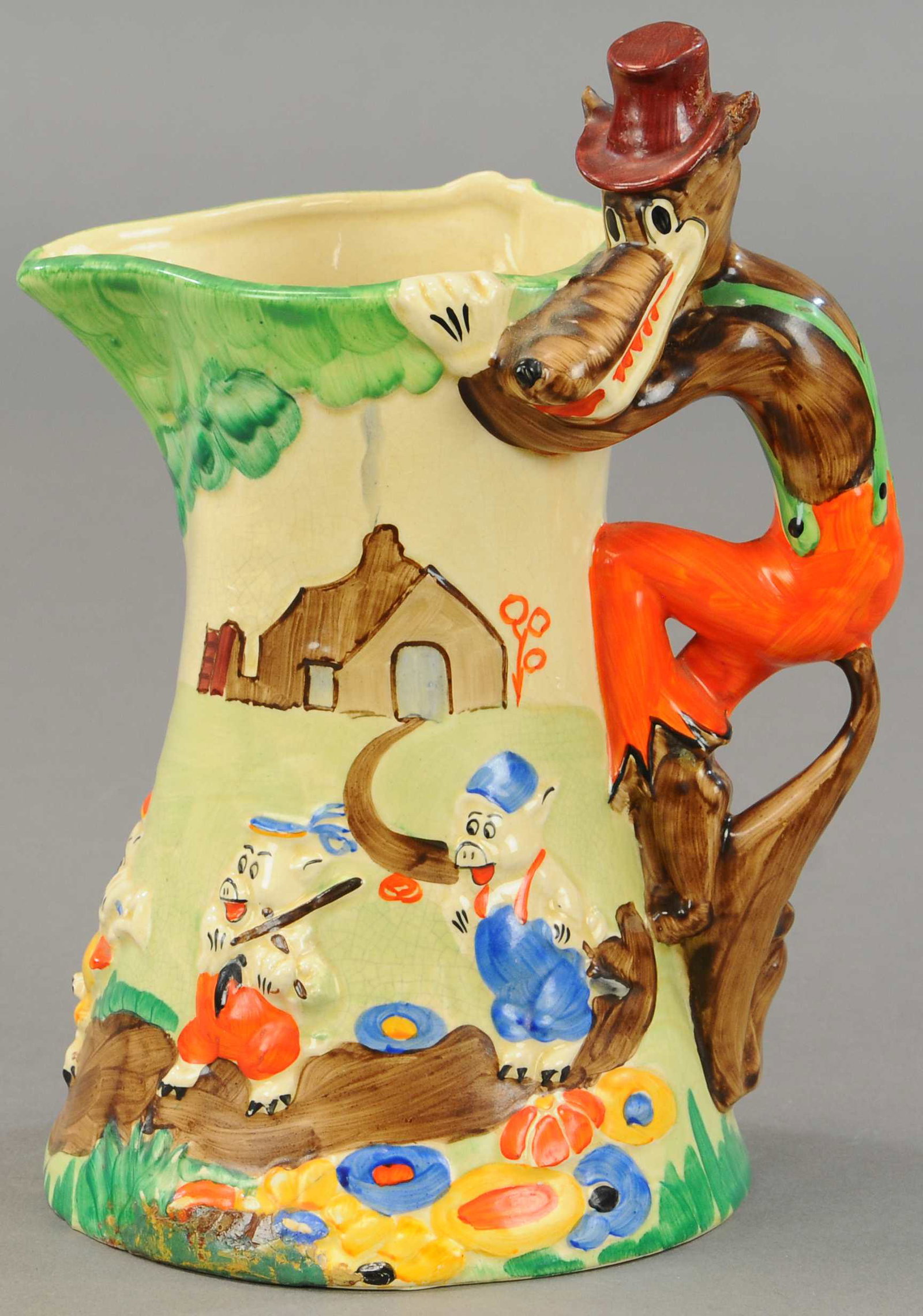 BIG BAD WOLF CERAMIC PITCHER: 284. BIG BAD WOLF CERAMIC PITCHER | Some age related crazing, repairs to base of pitcher and hat on wolf. | $150 - $300