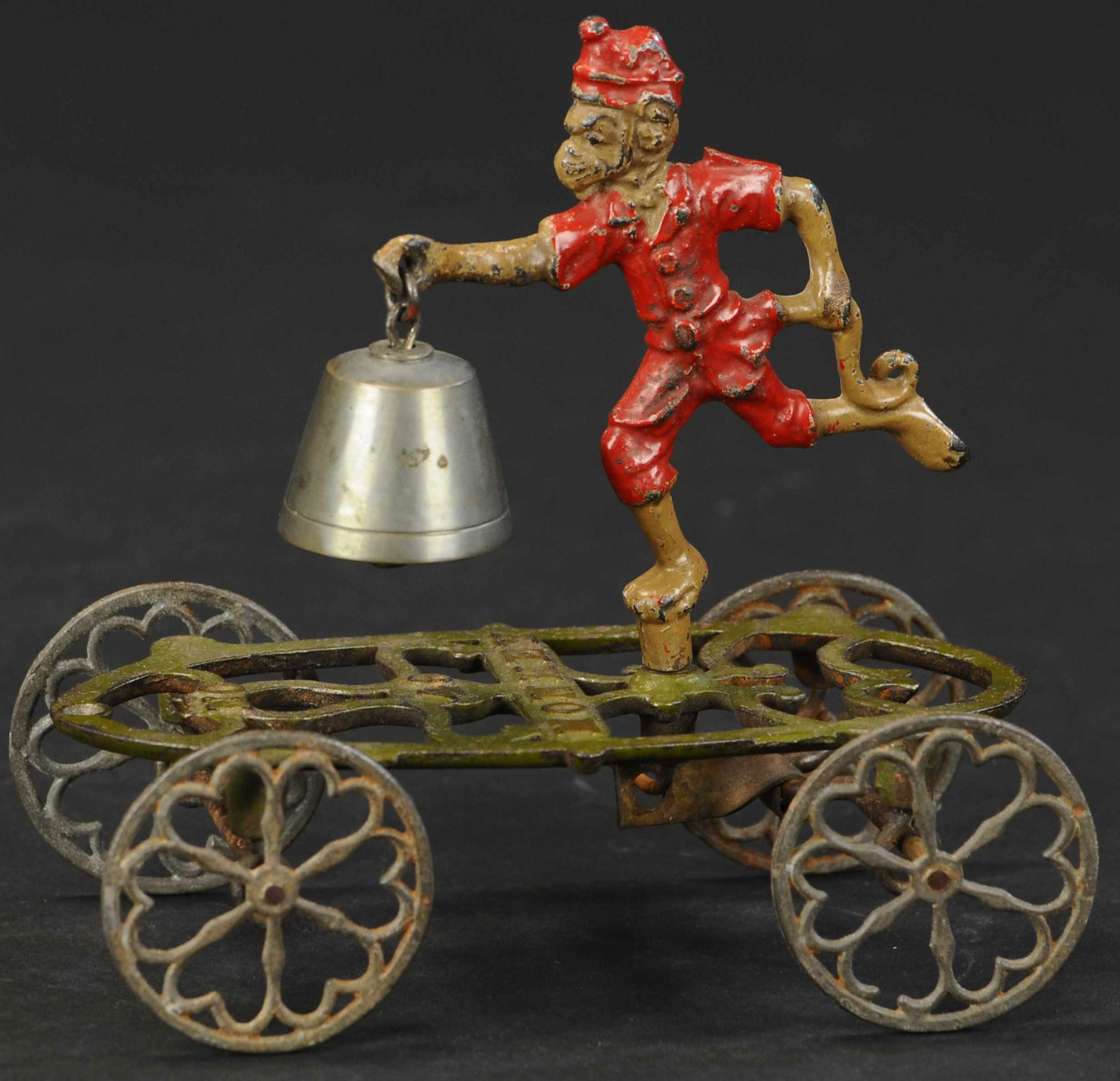 GONG BELL RUNNING MONKEY BELL TOY: 21. GONG BELL RUNNING MONKEY BELL TOY | Clean condition for this cute toy, as toy is pulled along, rear axle bar causes monkey to spin side to side ringing bell. Provenance: The Schroeder Collection.
