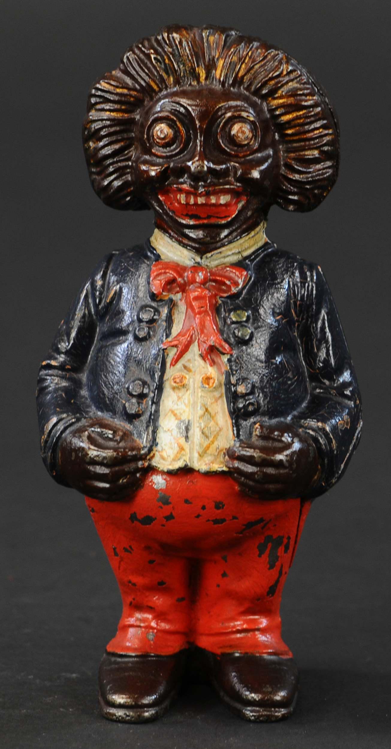 GOLLIWOG STILL BANK: 89. GOLLIWOG STILL BANK | John Harper Ltd., England. Provenance: The Schroeder Collection. | 6.5" h. | (Pristine Condition) | $400 - $600