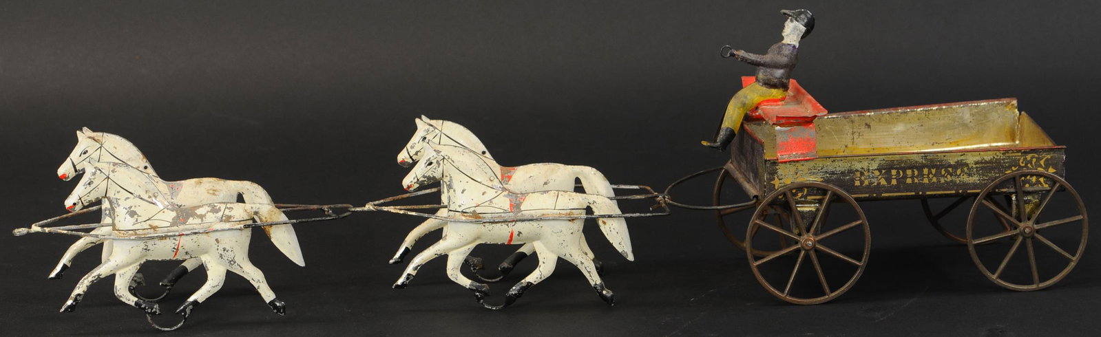 IVES TANDEM TEAM EXPRESS WAGON: 110. IVES TANDEM TEAM EXPRESS WAGON | Scarce toy, two pairs of side by side horses are in tandem to pull this early spirit painted cart, hand painted figure is fastened to open bench seat which reinfo