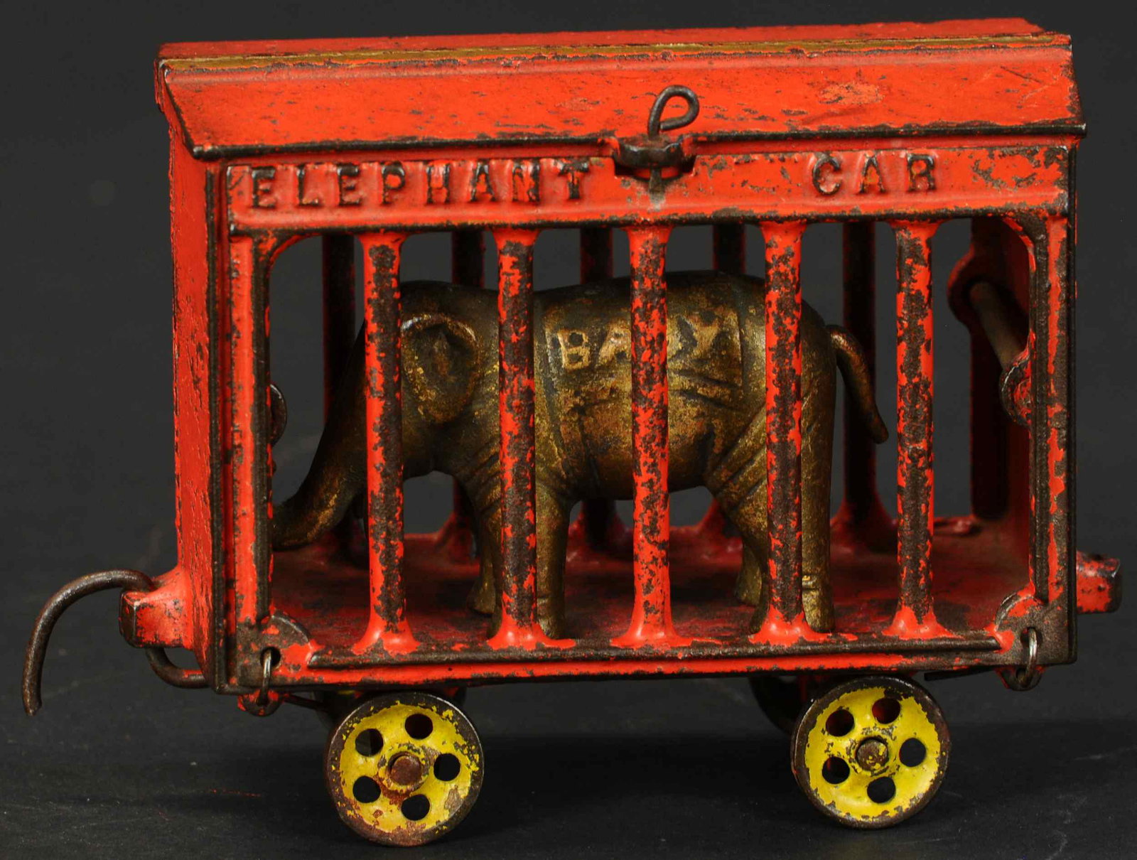 IVES BABY ELEPHANT CAR: 140. IVES BABY ELEPHANT CAR | A fairly scarce offering of circus cage RR car, embossed "Elephant Car" on sides, one cage side is hinged to allow removal of baby elephant. Provenance: The Schroeder Col