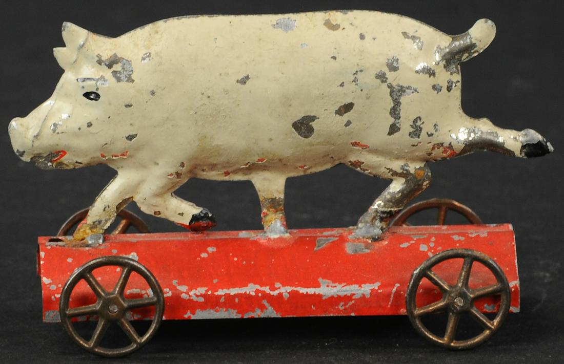 FALLOWS PIG ON PLATFORM TOY: 294. FALLOWS PIG ON PLATFORM TOY | Red base example is hand painted. Provenance: The Schroeder Collection. | 4.5" l. | Pig legs resoldered to base, overall in (Excellent Condition) | $300 - $500