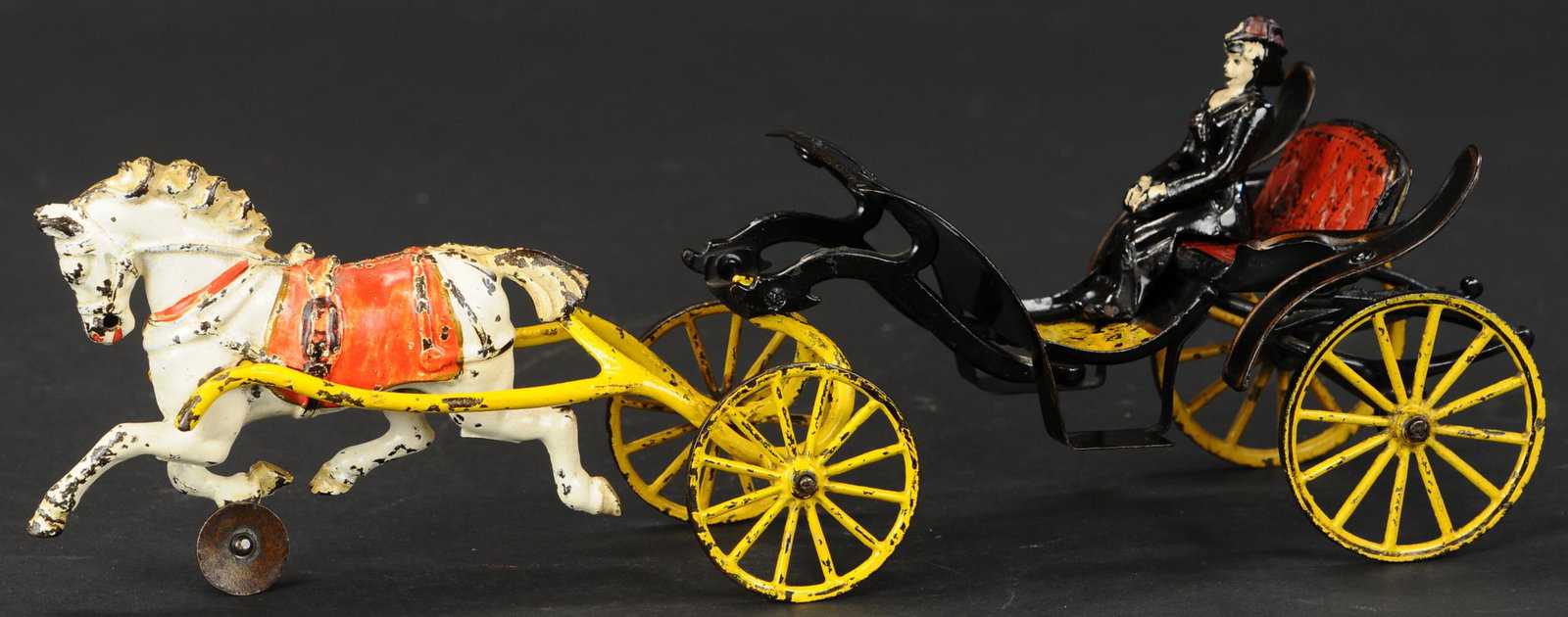PRATT & LETCHWORTH OPEN PHAETON: 310. PRATT & LETCHWORTH OPEN PHAETON | Elegant early carriage, open Phaeton design done in black with red spoke wheels. Provenance: The Schroeder Collection. | 15.5" l. | Guide wheel on horse replaced