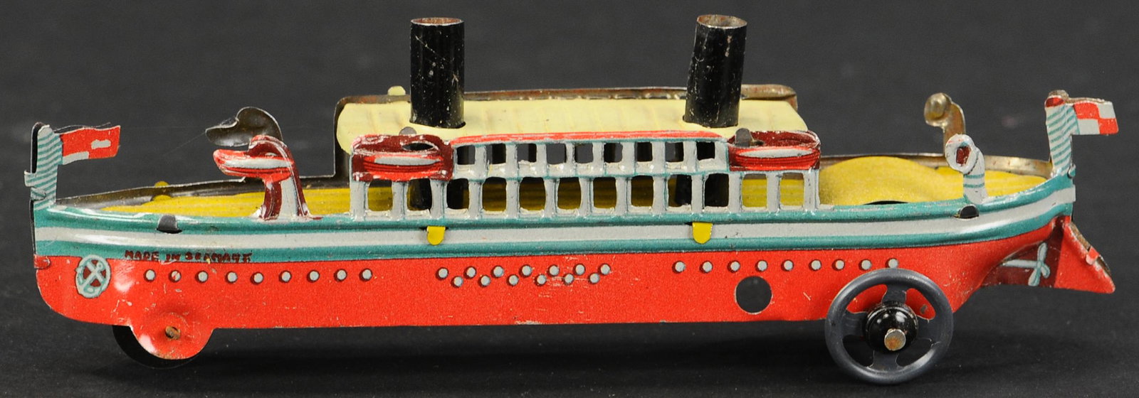 PASSENGER BOAT PENNY TOY: 384. PASSENGER BOAT PENNY TOY | Germany, attributed to Meier. Provenance: The Schroeder Collection. | 6" l. | (Pristine Condition) | $400 - $700