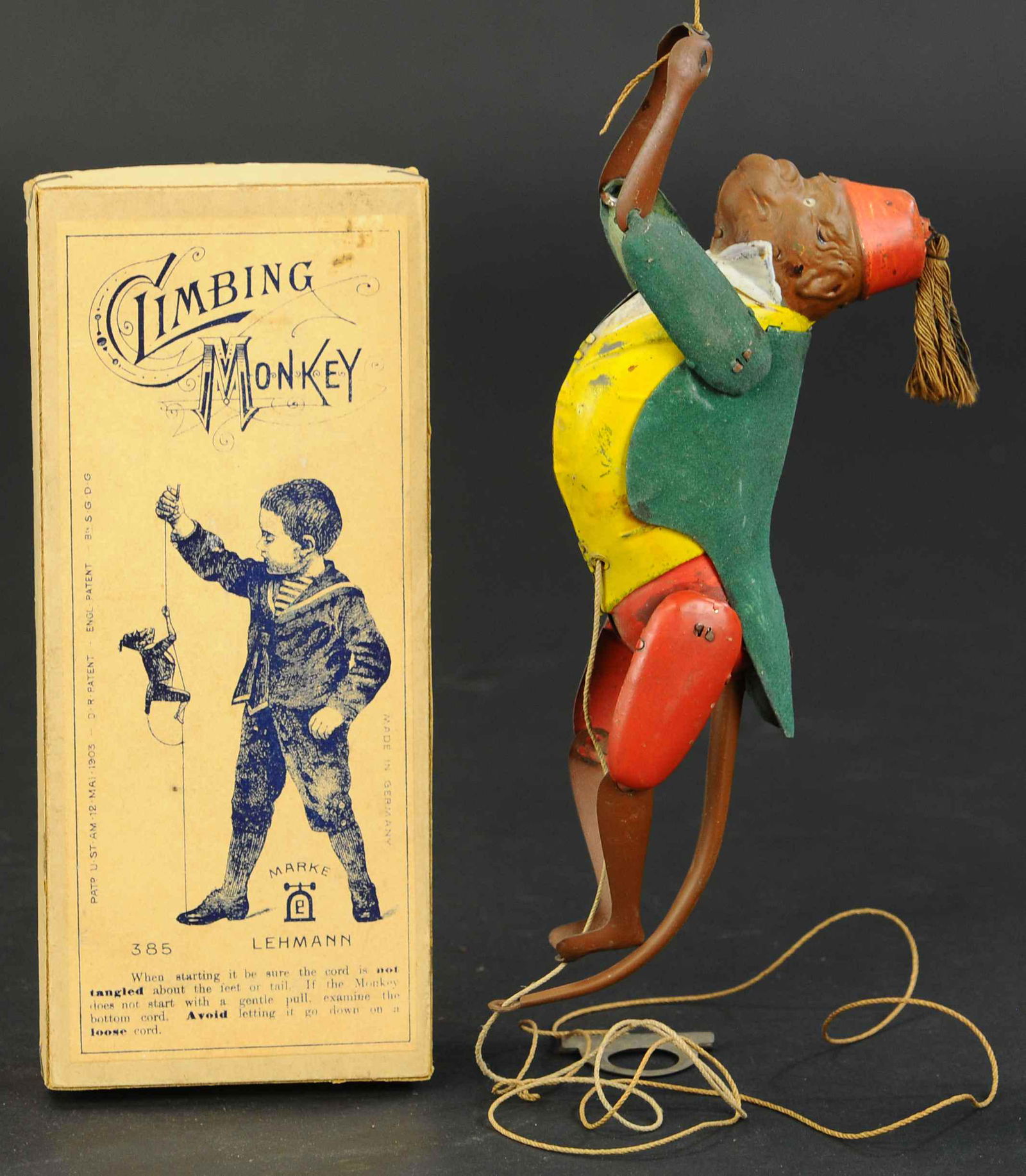 BOXED LEHMANN CLIMBING MONKEY: 413. BOXED LEHMANN CLIMBING MONKEY | Germany, popular pull string toy with inner mechanism allowing for simulated climbing action. Provenance: The Schroeder Collection. | 8" l. | Monkey's hair cue is