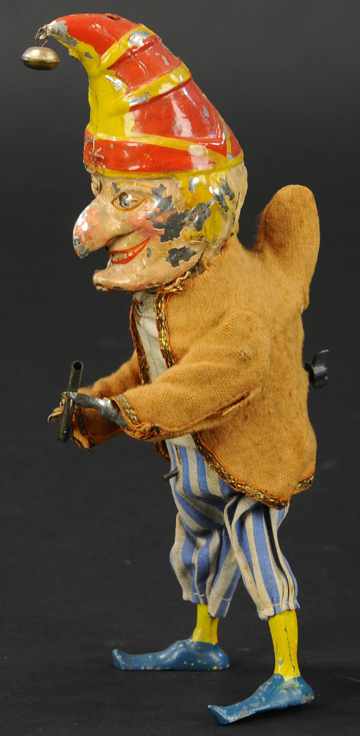 GERMAN PUNCH WALKER: 445. GERMAN PUNCH WALKER | Germany, Familiar Punch character hand painted waddling toy. Wind up tab appears at rear, Punch holds staff in hand. Provenance: The Schroeder Collection. | 8" h. | Flaking 