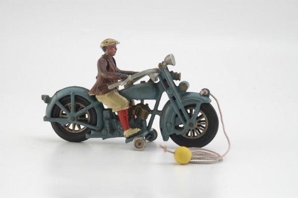 HUBLEY HARLEY DAVIDSON CYCLE WITH SPORT RIDER: Late 1920's, cast iron two cylinder Harley, painted in blue overall, gold engine highlights, partial decal on tank, features sport rider in period attire, aluminum handle bars, rubber tires with nicke