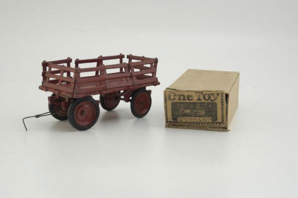 ARCADE BOXED WHITEHEAD & KALES WAGON: c. 1920's, cast iron, painted in red overall, features eight removable stake sides, embossed bed floor. 6 3/4" l.
