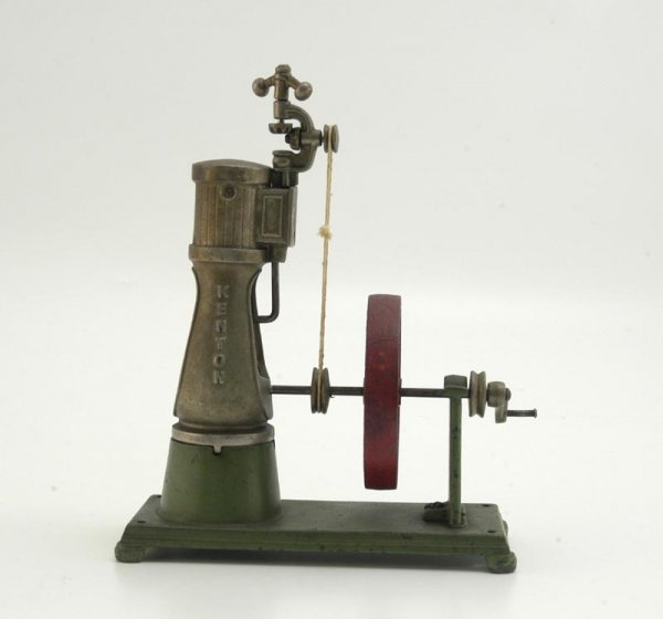 KENTON VERTICAL ENGINE: c. 1930, elusive cast iron working accessory, base painted in green, large red fly wheel, nickel pump housing, embossed lettering, hand crank operates internal gears. 10" h.