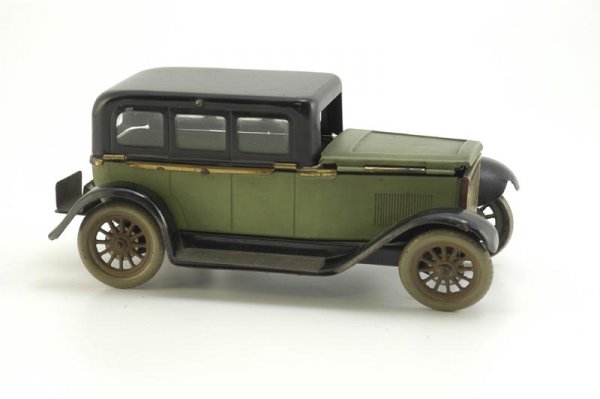 AUTO CIGARETTE BOX: Germany, tinplate auto is quite detailed, green body, black roof and full running boards, bonnet and roof lift for smoke storage, rear luggage rack fashioned for box of matches. 9" l.