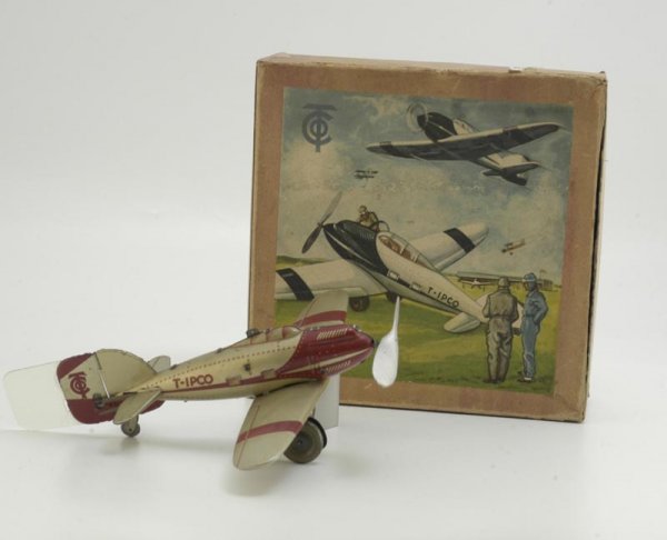 BOXED TIPPCO AIRPLANE: Germany, c. 1930's, lithographed tin, single prop with folding landing gear, clockwork driven, done in beige and red, celluloid tail wing, great box graphics. 10" wingspan.