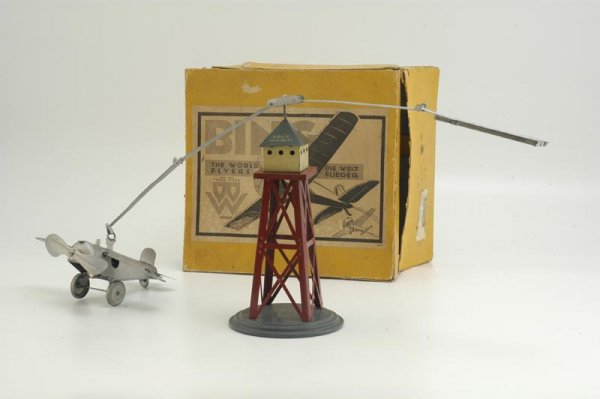 BOXED BING AIRPLANE WITH TOWER: Germany, c. 1930's, a very successful line of toys for Bing, this trestle tower has steel band holding clockwork airplane and weighted balance on other end, simple yet interesting action when activate