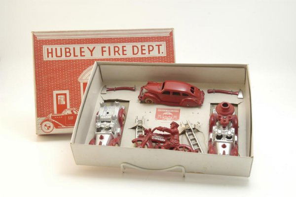 BOXED HUBLEY FIRE DEPT. SET NO. 30: c. 1930's, cast iron toys include fire ladder truck, fire pumper, sedan and Harley Davidson cycle with Police driver, red and silver colors, includes nickel plated ladders and two cast axes. Box 9" x