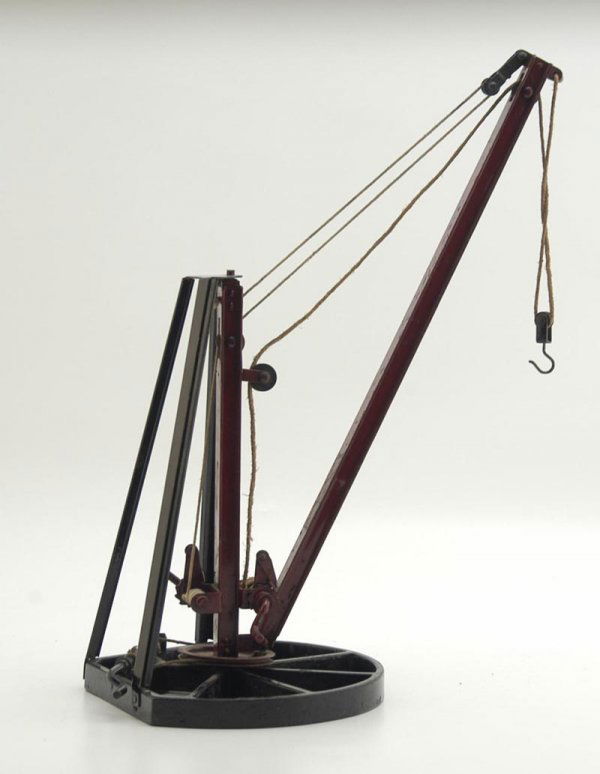 BUDDY "L" SMALL DERRICK: Cast iron base painted in black, red derrick able to swivel by hand lever as derrick can also be lowered or raised by additional lever. Provenance: Keats Collection. 20 1/2" h.