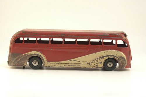 KINGSBURY GREYHOUND BUS: c. 1938, pressed steel, painted in red and white, marquee reads "New York," rubber tires, clockwork driven, nickeled lights and grille. 16 1/2" l.
