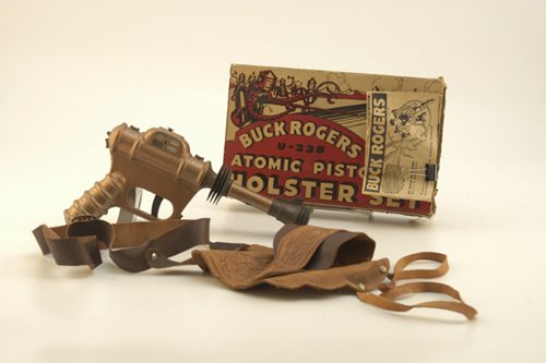 BUCK ROGERS ATOMIC PISTOL AND HOLSTER SET: Daisy Mfg., Model U-238, pistol done in copper color pressed steel, comes with leather holster, small four page adventure booklet and original outer box; a hard to find set. Pistol, 9 1/2" l.