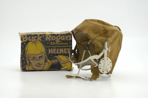 BUCK ROGERS HELMET WITH BOX: Manufactured by Daisy Co., early leather helmet has embossed chrome ear covers along with celluloid eye shield, accompanied by original box with Buck Rogers head shot. 5 1/2" x 8" box.