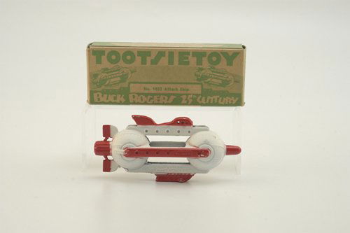 BOXED TOOTSIETOY BUCK ROGERS ATTACK SHIP: Red and white paint combination, die-cast metal in form of futuristic space ship. 4 1/2" l.