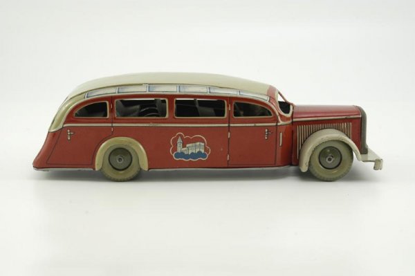 TIPPCO TOUR BUS: Germany, c. 1930's, a very attractive example, lithographed tin, castle graphics on sides, seated driver, done in colorful red body, tan roof and fenders, clockwork driven, classic Euro tourer with be