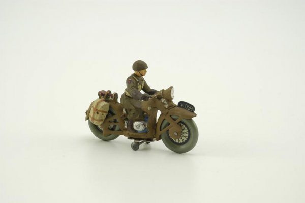 HAUSSER MILITARY CYCLE WITH RIDER: Germany, c. 1930's, composition and tinplate, well molded, details include saddle bags on rear seat, litho wheels. 4" l.