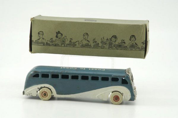 ARCADE BOXED COAST TO COAST BUS: Cast iron, painted in blue with white side highlights, roof stenciled "Coast to Coast?GMC," nickel plated front and rear grille, white rubber tires. 9" l.