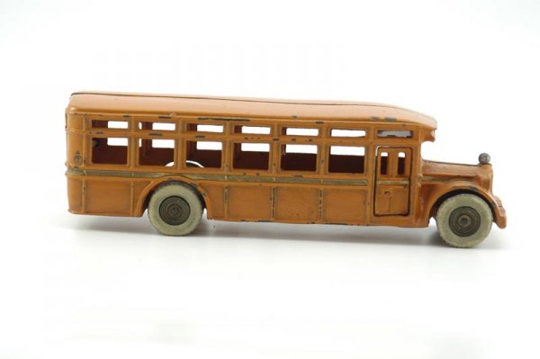 ARCADE "ACF" BUS: c. 1927, cast iron, very scarce example, painted in orange, made for the American Car & Foundry Co., cast iron with rubber tires, front grille embossed "ACF," passenger door fully opening. 11 1/4" l.