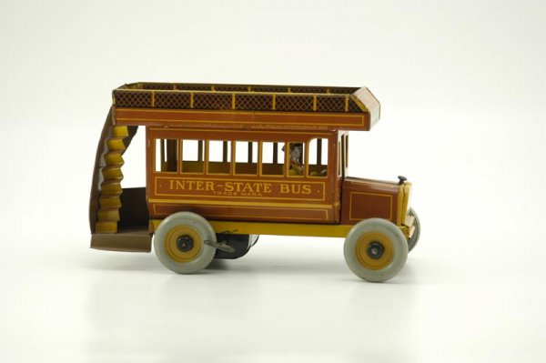 BOXED STRAUSS INTER-STATE BUS: Lithographed tin, brown version, upper deck seating and rear stairs, clockwork driven, seated driver, metal wheels. 10 1/2" l.