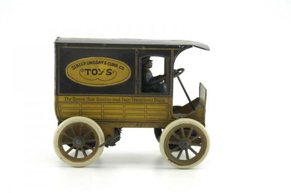 HANS EBERL "SIBLEY TOYS" DELIVERY VAN: Germany, c. 1920's, lithographed tin, made for the American market, great side ad reads "Sibley Lindsay & Curr Co. Toys," seated driver, clockwork driven, done in familiar yellow and black body. 7" l.