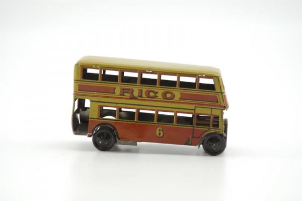 RICO AUTOBUS: Spain, c. 1940, lithographed tin, bright tin lithography, typical double decker city bus, reads "Rico" on sides, keywind barrel spring mechanism, done in yellows and red. 6" l.